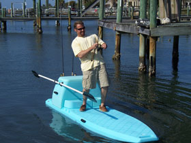 Photo of Man fishing off a Stand_up Paddle Board.